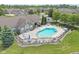 Aerial view of the community pool with lounge chairs and patio furniture surrounded by a black fence at 1146 Distinctive Way, Greenfield, IN 46140