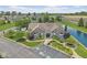 Aerial view of community clubhouse featuring manicured landscaping, a water feature, and ample parking at 1146 Distinctive Way, Greenfield, IN 46140