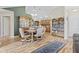 Well-lit dining area with hardwood floors, built-in shelving, and an adjacent kitchen, great for entertaining at 1146 Distinctive Way, Greenfield, IN 46140