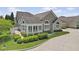 Beautiful home exterior boasts stone accents, manicured landscaping, and ample natural light at 1146 Distinctive Way, Greenfield, IN 46140