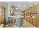 Eat-in kitchen featuring wood cabinets, bar seating, and tile floors for a cozy feel at 1146 Distinctive Way, Greenfield, IN 46140