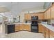 Kitchen with black appliances, wood cabinets, and recessed lighting is perfect for cooking at 1146 Distinctive Way, Greenfield, IN 46140