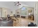 Bright living room features a cozy fireplace, large arched window, and hardwood floors, creating a warm ambiance at 1146 Distinctive Way, Greenfield, IN 46140