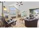 Spacious living room with hardwood floors, a fireplace, arched window, and seamless transition to other living areas at 1146 Distinctive Way, Greenfield, IN 46140