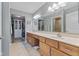 Well-lit bathroom with double vanity, large mirror, walk-in closet and tile floor at 1146 Distinctive Way, Greenfield, IN 46140