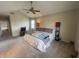 Comfortable bedroom with vaulted ceilings, a ceiling fan, ample natural light, and neutral color scheme at 11621 Coastal Dr, Indianapolis, IN 46229