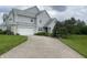 Inviting two-story home with a two car garage, neutral siding, manicured lawn, and mature trees at 11621 Coastal Dr, Indianapolis, IN 46229