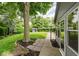 Landscaped backyard featuring a lush lawn, mature trees, a storage shed, and a charming pathway to the house at 12112 Roxbury Pl, Carmel, IN 46033