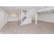 Finished basement with gray carpet and stairs leading to the upper level at 12112 Roxbury Pl, Carmel, IN 46033
