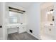Bright bathroom featuring a vanity with drawers and cabinet space, plus a mirrored vanity and carpeted floor at 12112 Roxbury Pl, Carmel, IN 46033