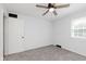 Well-lit bedroom with plush carpet, ceiling fan, and a window that provides natural light at 12112 Roxbury Pl, Carmel, IN 46033