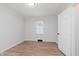 Bright bedroom featuring hardwood floors, a window and white painted walls at 12112 Roxbury Pl, Carmel, IN 46033