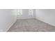 Bedroom features neutral carpet, white walls, and two windows at 12112 Roxbury Pl, Carmel, IN 46033