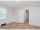 Bright bedroom featuring hardwood floors, a window and white painted walls at 12112 Roxbury Pl, Carmel, IN 46033