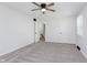 Spacious bedroom with neutral carpet, ceiling fan, and doorways that lead to other rooms at 12112 Roxbury Pl, Carmel, IN 46033