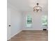 Bedroom featuring wood-look floors, white trim, and modern lighting at 12112 Roxbury Pl, Carmel, IN 46033