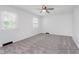 Bright bedroom featuring neutral carpeting, a ceiling fan, and a window that provides natural light at 12112 Roxbury Pl, Carmel, IN 46033