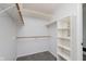 Walk-in closet with wooden and white shelving provides ample storage space and organization at 12112 Roxbury Pl, Carmel, IN 46033