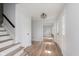 Inviting foyer with hardwood floors, stairs to the upper level, and modern lighting fixture at 12112 Roxbury Pl, Carmel, IN 46033