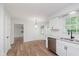 Eat-in kitchen with white cabinets, stainless steel appliances, and wood-look floors at 12112 Roxbury Pl, Carmel, IN 46033