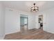 Living room with wood-look floors, white trim, and views into the kitchen at 12112 Roxbury Pl, Carmel, IN 46033