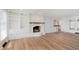 Bright living room with a white painted brick fireplace and built in shelves and cabinets at 12112 Roxbury Pl, Carmel, IN 46033