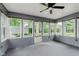 Enclosed sunroom with multiple windows offering natural light and outdoor views at 12112 Roxbury Pl, Carmel, IN 46033