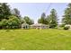 Large backyard featuring a gazebo, mature trees, and well-maintained lawn, perfect for outdoor activities at 132 S First St, Jamestown, IN 46147