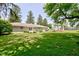 Backyard showcasing a stone house exterior and a gazebo with surrounding lush lawn and greenery at 132 S First St, Jamestown, IN 46147