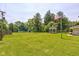 Extensive yard space featuring a gazebo, mature trees, and a lush lawn with an American flag waving at 132 S First St, Jamestown, IN 46147