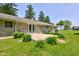 Expansive backyard featuring a well-maintained lawn, a stone patio, and lush green landscaping at 132 S First St, Jamestown, IN 46147