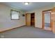 Bedroom featuring carpeting, a window with floral curtains, and a closet with wooden doors at 132 S First St, Jamestown, IN 46147
