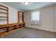 Bedroom with custom shelving/cabinetry on the wall and a window with white sheer curtains at 132 S First St, Jamestown, IN 46147