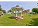 Close-up of gazebo in backyard with brick foundation and surrounding lawn at 132 S First St, Jamestown, IN 46147