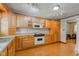 Bright kitchen with light wood cabinets, white appliances, and laminate flooring at 132 S First St, Jamestown, IN 46147