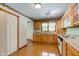 Charming kitchen with wood cabinets, laminate flooring, and ample natural light at 132 S First St, Jamestown, IN 46147