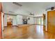 Spacious living room featuring hardwood floors, a fireplace, and access to the kitchen at 132 S First St, Jamestown, IN 46147