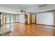 Bright living room featuring hardwood floors, a grandfather clock, and a ceiling fan at 132 S First St, Jamestown, IN 46147