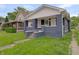 Charming bungalow featuring a covered front porch with detailed columns and a cozy entrance at 1411 N Grant Ave, Indianapolis, IN 46201