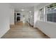 Open floor plan showcasing a modern kitchen with stainless steel appliances and bright white cabinetry at 1411 N Grant Ave, Indianapolis, IN 46201