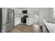 Modern kitchen featuring stainless steel appliances, white cabinetry, and sleek countertops at 1411 N Grant Ave, Indianapolis, IN 46201