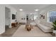 Bright, open-concept living room with modern decor, wood floors, and abundant natural light at 1411 N Grant Ave, Indianapolis, IN 46201