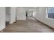 Spacious room featuring wood floors and generous natural light, enhanced by a minimalist aesthetic at 1411 N Grant Ave, Indianapolis, IN 46201
