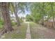 Long backyard featuring mature trees and a stone walkway at 1425 N Grant Ave, Indianapolis, IN 46201