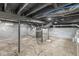 Unfinished basement with gray walls and exposed ceiling beams at 1425 N Grant Ave, Indianapolis, IN 46201