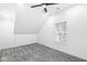 Bright bedroom features textured ceilings, a window, and a modern ceiling fan at 1425 N Grant Ave, Indianapolis, IN 46201