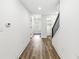 Hallway featuring hardwood floors and staircase with black iron railing at 1425 N Grant Ave, Indianapolis, IN 46201