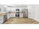 Modern kitchen featuring stainless steel appliances, white cabinets, and wood countertops at 1425 N Grant Ave, Indianapolis, IN 46201