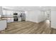 Modern kitchen with white cabinets, stainless steel appliances, and wood-look flooring at 1425 N Grant Ave, Indianapolis, IN 46201