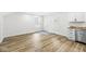 Bright living room with fresh paint, two windows, and wood-look flooring at 1425 N Grant Ave, Indianapolis, IN 46201